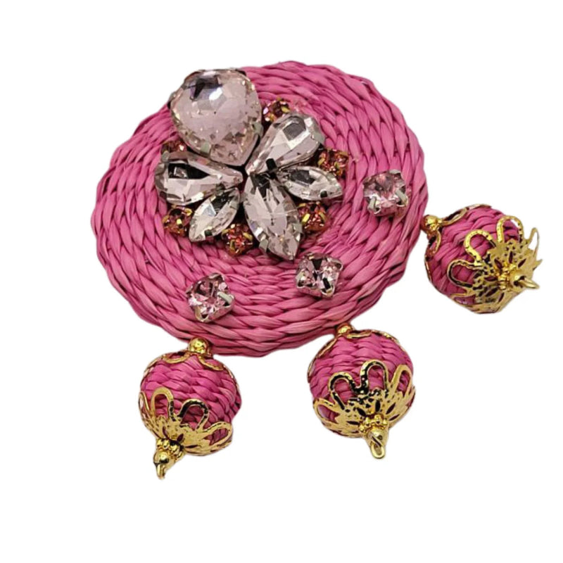 These elegant earrings are designed with a vibrant pink woven base featuring a stunning crystal flower accent in the center, 