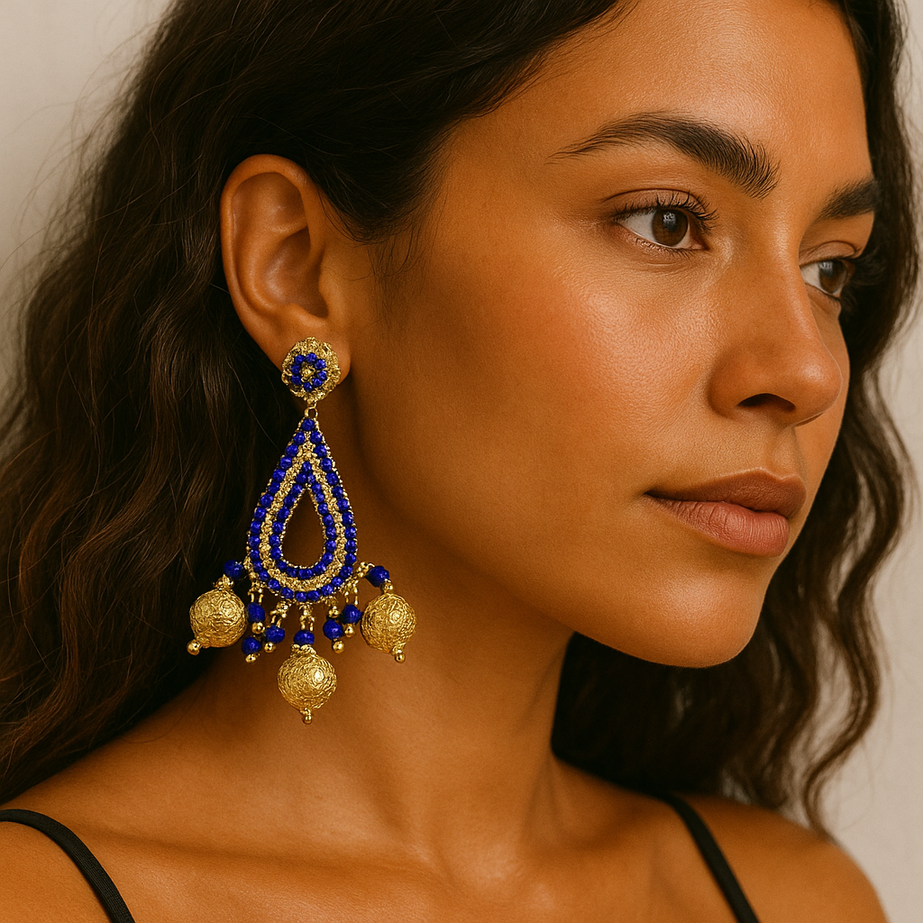 Model wearing Royal Drop Beaded Earrings with blue and gold beads, teardrop shape, golden charms — handcrafted in Colombia