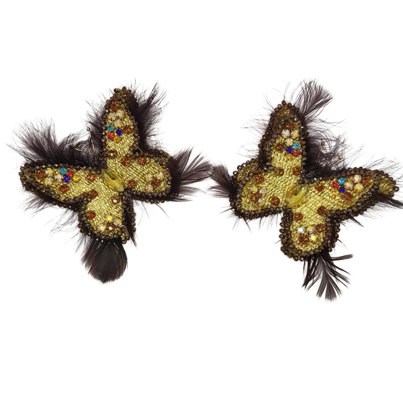 These gorgeous earrings feature a butterfly-like shape, intricately embroidered with small Murano stones, and bordered with colored Murano stones along the edges of the feathers. Symbolizing transformation, like the passage from 1st Corinthians 15:40—"I will transform myself, we could walk on water and fly like butterflies"—these earrings are crafted from Banana Tree Fibers.