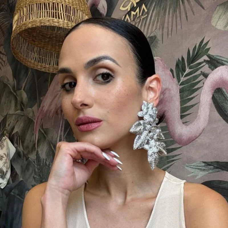 Close-up of a girl wearing a sparkling silver floral earring.