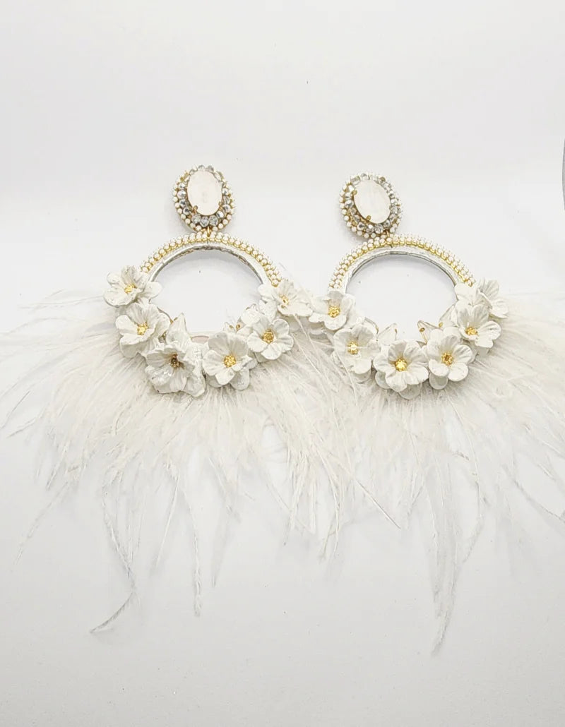 Handcrafted Silver Totumo Earrings: Featuring Double Crescent Moon Design adorned with Delicate White Banana Fiber Flowers with Golden Accents, embellished with White and Gold Gemstones, and adorned with Delicate Feathers cascading from the flowers.