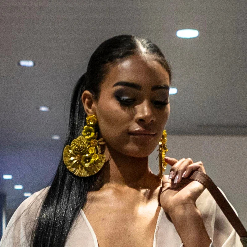 woman wearing statement earrings