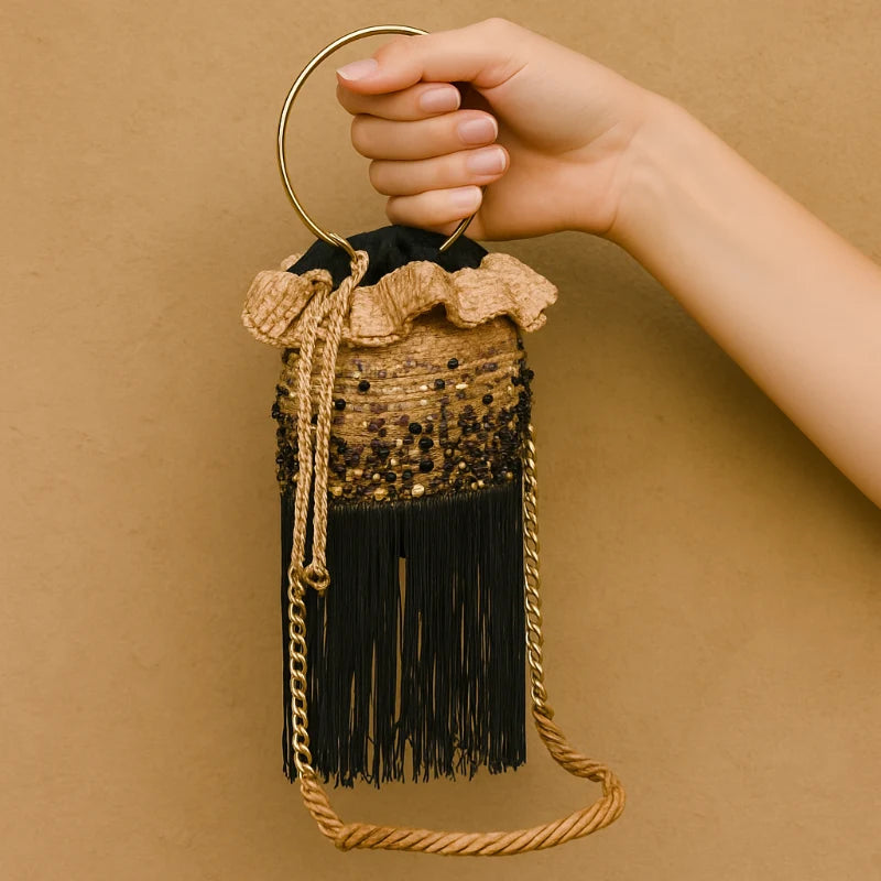This Stones Mix Bucket Bag is stylish and fun. It features Murano stones all around and gold-tone strap hardware. The design is great for nighttime use at events. Soft fringe at the bottom adds movement. Made with sustainable banana tree fibers.