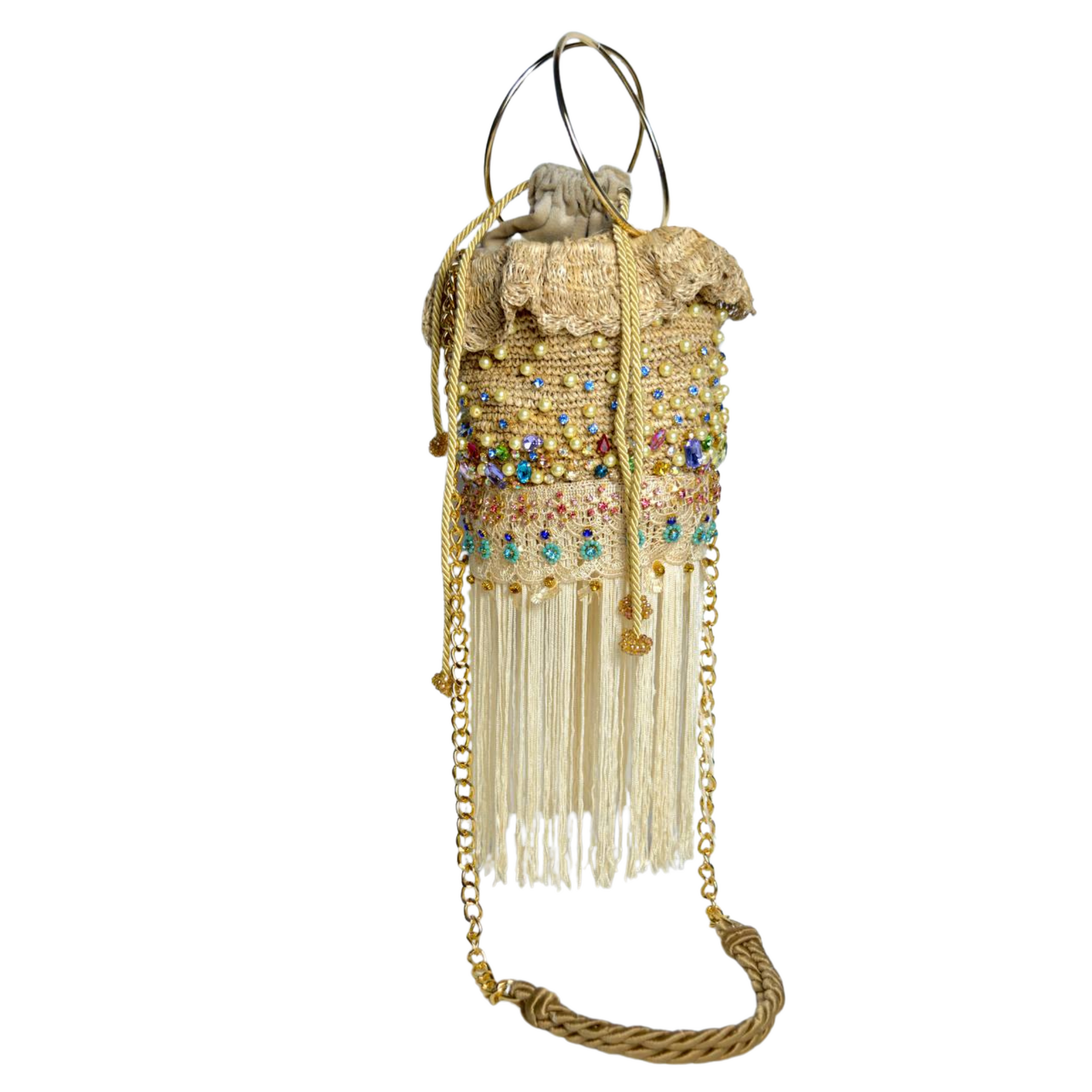 Natural fiber bucket bag with multicolor bead details, gold chain strap, and ivory fringe trim