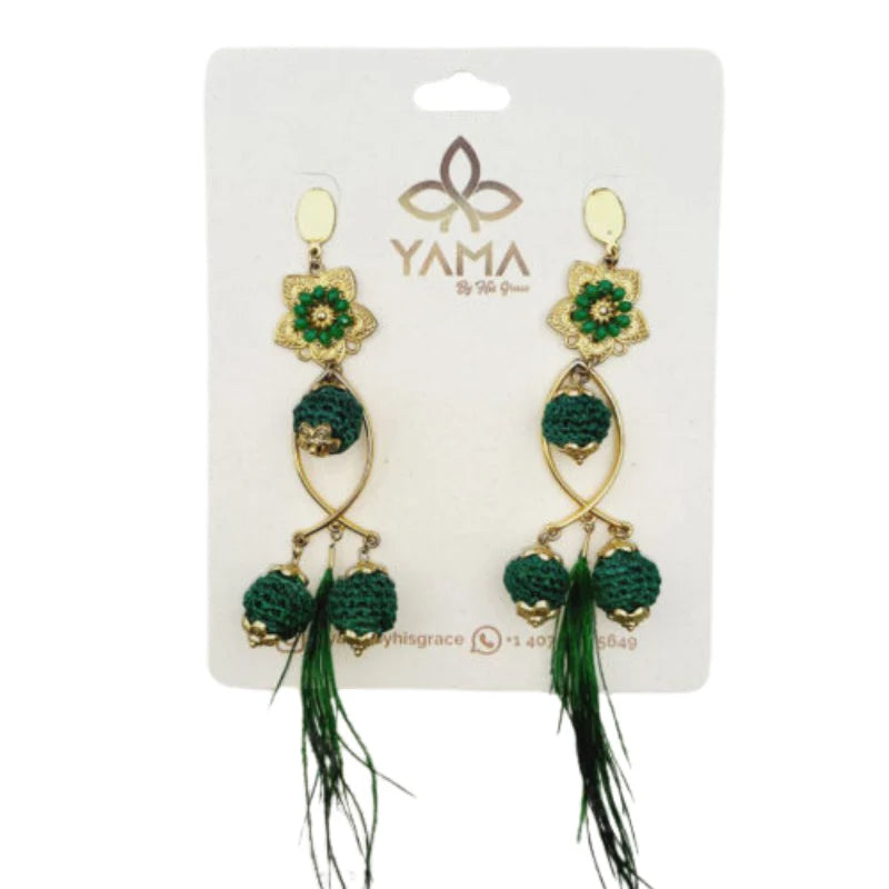 A pair of gold and white fisherman earrings with intricate beadwork and feathered tassels.