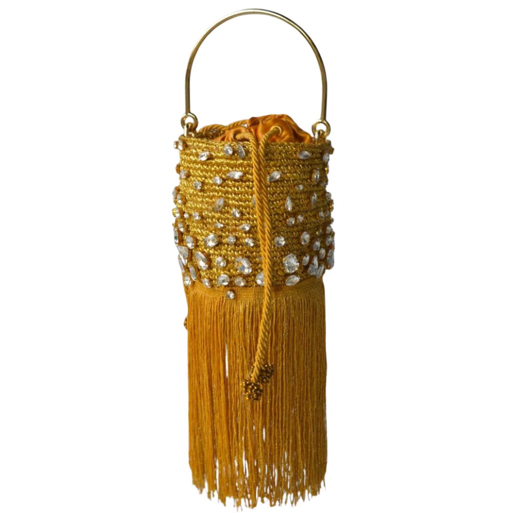 Small gold bucket bag with crystal embellishments and long gold fringe detail, shown against a white background.