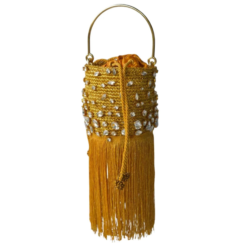This yellow minaudière bag is made from gold-plated banana tree fibers and decorated with Murano stones in yellow and white for a bright touch. It includes a Murano stone tassel and a gold chain.