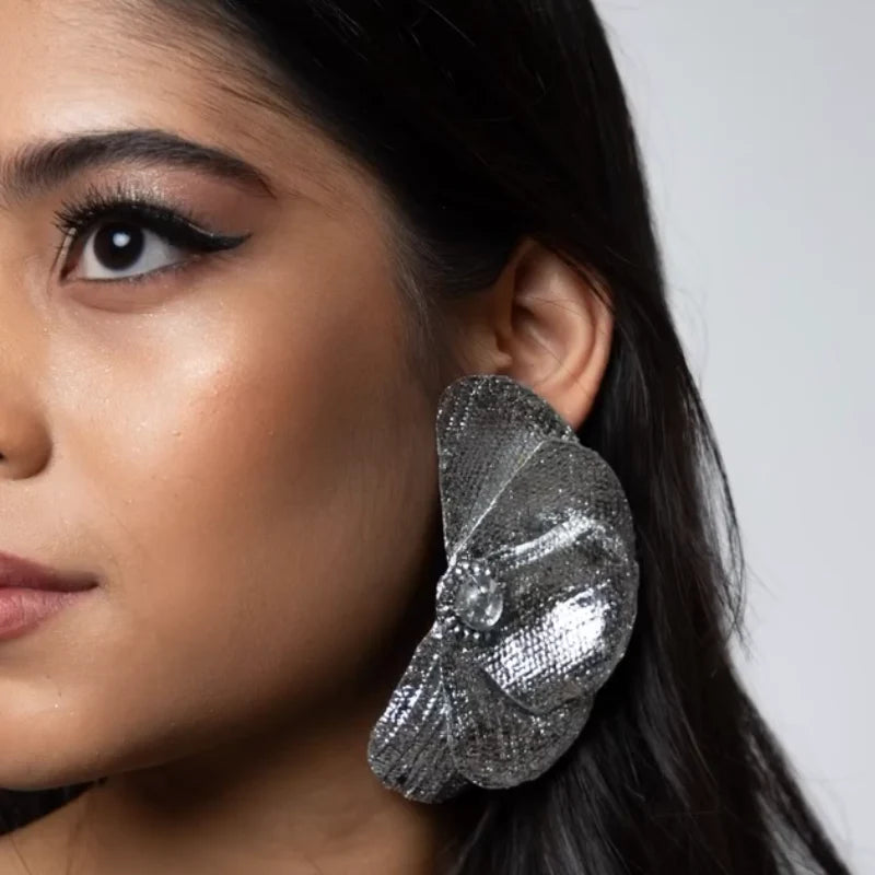 woman wearing a big petal earrings 