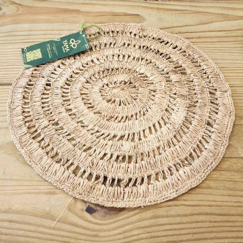 this placemat stands out for its intricate openwork circular pattern and flawless organic texture