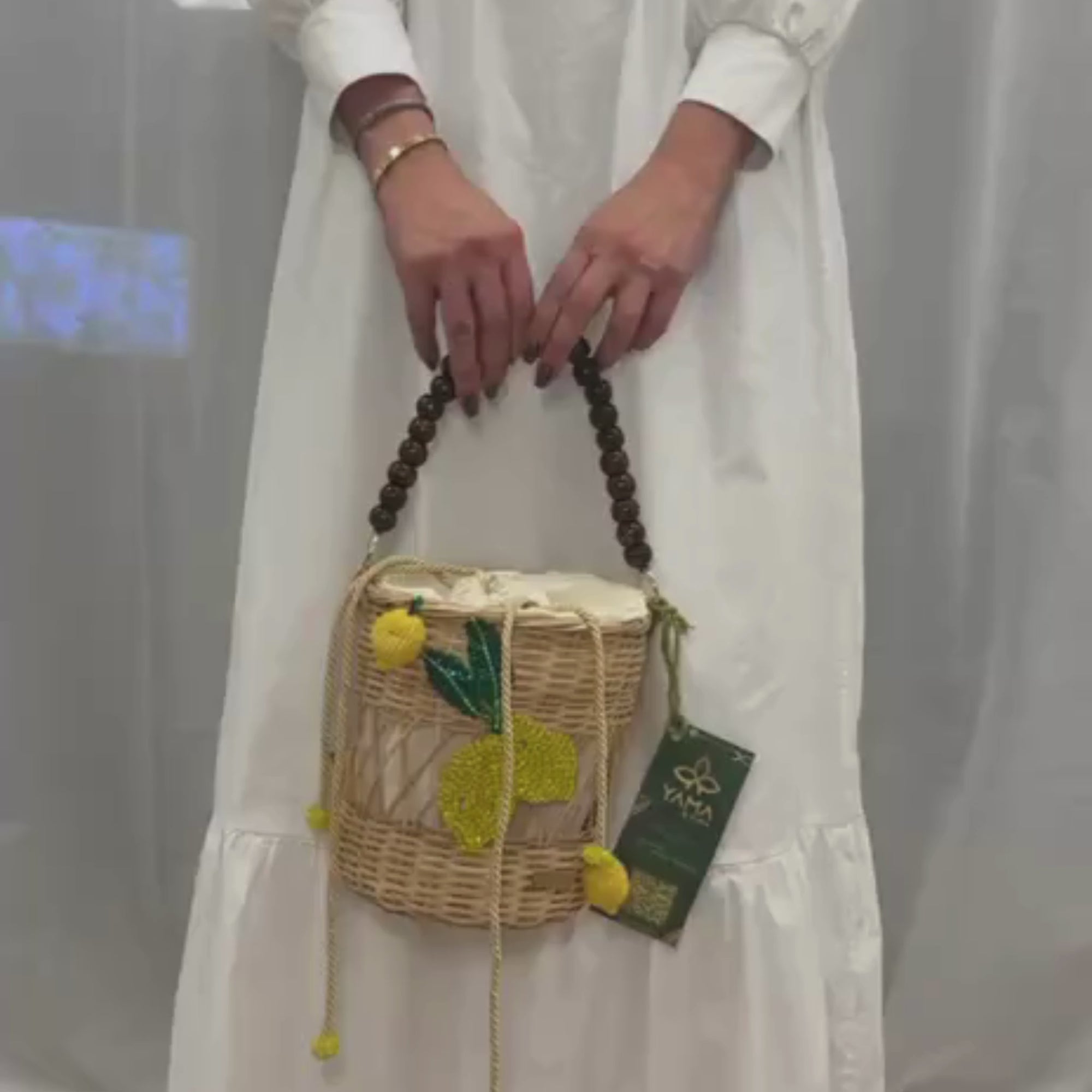 Handcrafted Lemon Delight Handbag featuring beaded lemon motif and wooden handle, shown in motion to highlight its texture and playful design
